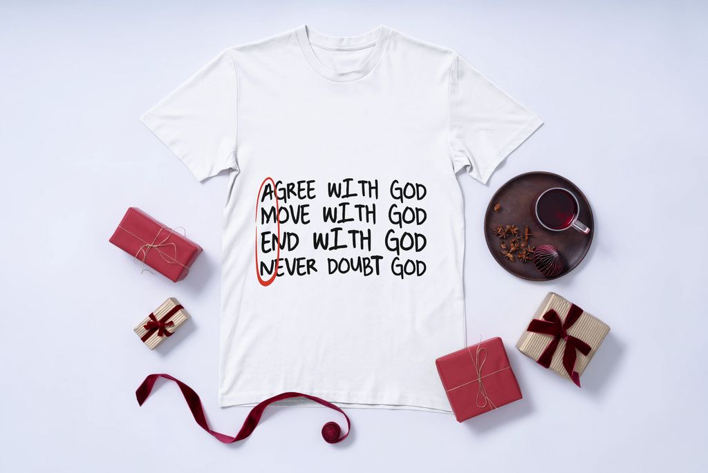 White t-shirt with motivational quote Agree with God Move with God End with God Never Doubt God, surrounded by small gift boxes and a cup on a light gray background