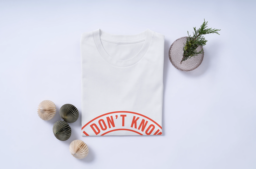White t-shirt with 'I DON'T KNOW' print on a light gray background